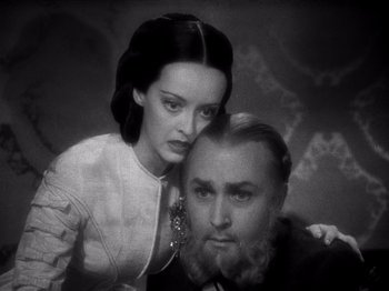 Movie still from “Juarez” (1939), directed by William Dieterle – A man and a woman pose for a picture; Close Up shot, High angle