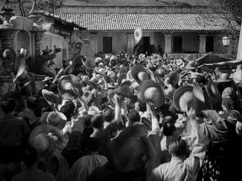 Movie still from “Juarez” (1939), directed by William Dieterle – An old photo of a crowd of people with hats; Extreme Wide shot, High angle