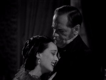 Movie still from “Juarez” (1939), directed by William Dieterle – An older man and a younger woman are smiling together; Close Up shot, High angle