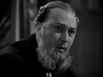 Movie still from “Juarez” (1939), directed by William Dieterle – A man with a long beard is looking at the camera; Close Up shot, Low angle