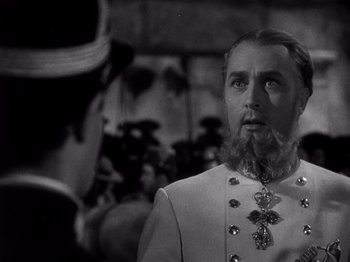 Movie still from “Juarez” (1939), directed by William Dieterle – A man with a long beard is talking to another man; Close Up shot, Low angle