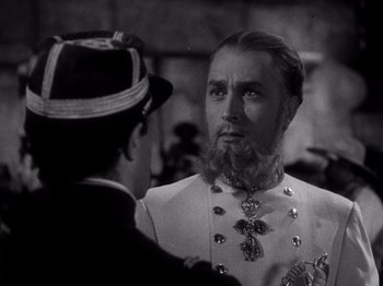 Movie still from “Juarez” (1939), directed by William Dieterle – A man with a long beard talking to another man in a suit; Close Up shot, Over the shoulder angle