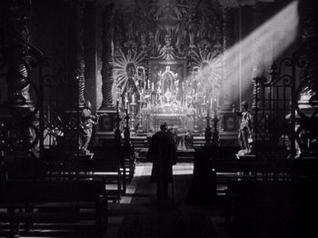 Movie still from “Juarez” (1939), directed by William Dieterle – A man standing in front of an altar in a church; Wide shot, Low angle