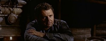 Movie still from “Jubal” (1956), directed by Delmer Daves – A person sitting on a couch; Close Up shot, Low angle