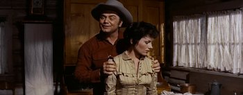 Movie still from “Jubal” (1956), directed by Delmer Daves – A man and a woman in a western style outfit; Medium shot, Over the shoulder angle