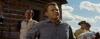 Movie still from “Jubal” (1956), directed by Delmer Daves – A person standing near a building; Medium shot, Low angle