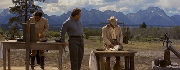 Movie still from “Jubal” (1956), directed by Delmer Daves – Two men standing next to each other on a field; Wide shot, Low angle