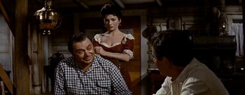 Movie still from “Jubal” (1956), directed by Delmer Daves – A man and a woman are standing in front of another man; Medium shot, Over the shoulder angle