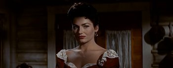 Movie still from “Jubal” (1956), directed by Delmer Daves – A beautiful woman in a red and white dress; Close Up shot, Low angle