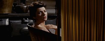 Movie still from “Jubal” (1956), directed by Delmer Daves – A woman looking in a mirror while holding her hand up to her chest; Close Up shot, Over the shoulder angle