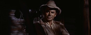 Movie still from “Jubal” (1956), directed by Delmer Daves – A person wearing a hat; Medium shot, Over the shoulder angle