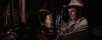 Movie still from “Jubal” (1956), directed by Delmer Daves – A woman and a man are talking to each other; Medium shot, Low angle