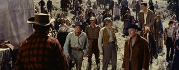 Movie still from “Jubal” (1956), directed by Delmer Daves – A large group of people standing in a field; Wide shot, High angle
