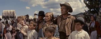 Movie still from “Jubal” (1956), directed by Delmer Daves – A group of people standing next to each other on a field; Medium shot, Low angle