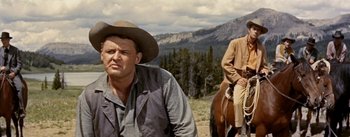Movie still from “Jubal” (1956), directed by Delmer Daves – A man and a woman on a horse in a field; Medium shot, Low angle