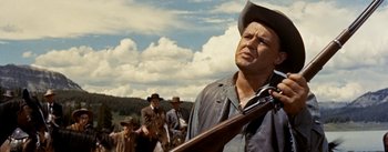 Movie still from “Jubal” (1956), directed by Delmer Daves – A group of men standing next to each other on top of a hill; Medium shot, Low angle