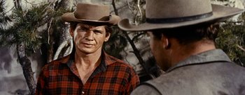 Movie still from “Jubal” (1956), directed by Delmer Daves – A man wearing a cowboy hat talking to another man; Close Up shot, Over the shoulder angle