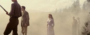 Movie still from “Jubal” (1956), directed by Delmer Daves – A woman standing in front of a man in a field; Wide shot, Low angle