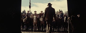 Movie still from “Jubal” (1956), directed by Delmer Daves – A group of men on horses standing next to each other on a field; Wide shot, Low angle