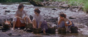 Movie still from “Jude” (1996), directed by Michael Winterbottom – A group of people sitting in a river; Wide shot, High angle