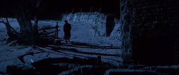 Movie still from “Jude” (1996), directed by Michael Winterbottom – A man standing on a snowy field at night; Extreme Wide shot, High angle