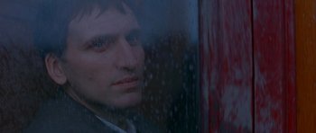 Movie still from “Jude” (1996), directed by Michael Winterbottom – A person looking through a window; Close Up shot, Over the shoulder angle