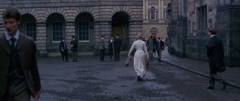 Movie still from “Jude” (1996), directed by Michael Winterbottom – A group of people walking down a street; Extreme Wide shot, High angle