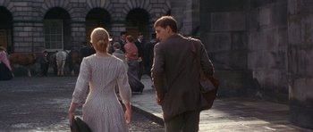 Movie still from “Jude” (1996), directed by Michael Winterbottom – A man and a woman walking down a street; Wide shot, Over the shoulder angle