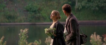 Movie still from “Jude” (1996), directed by Michael Winterbottom – A man and a woman standing next to a body of water; Medium shot, Over the shoulder angle