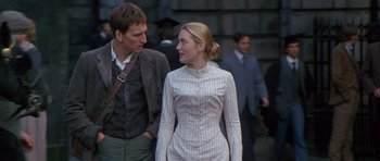 Movie still from “Jude” (1996), directed by Michael Winterbottom – A man and a woman walking down a street; Medium shot, Over the shoulder angle