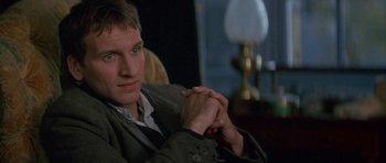 Movie still from “Jude” (1996), directed by Michael Winterbottom – A person sitting on a couch; Close Up shot, Over the shoulder angle