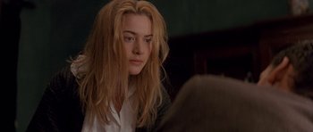 Movie still from “Jude” (1996), directed by Michael Winterbottom – A woman with long blonde hair sitting in front of another woman; Close Up shot, Over the shoulder angle