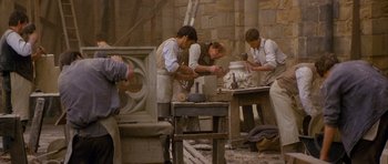 Movie still from “Jude” (1996), directed by Michael Winterbottom – A group of men working in a pottery workshop; Wide shot, High angle