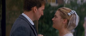 Movie still from “Jude” (1996), directed by Michael Winterbottom – A man and a woman looking at each other in front of a building; Close Up shot, Over the shoulder angle