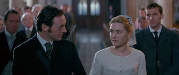 Movie still from “Jude” (1996), directed by Michael Winterbottom – A man and a woman standing next to each other; Close Up shot, Over the shoulder angle