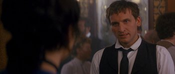 Movie still from “Jude” (1996), directed by Michael Winterbottom – A man wearing a black tie and a white shirt; Close Up shot, Over the shoulder angle