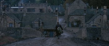 Movie still from “Jude” (1996), directed by Michael Winterbottom – A man walking down a dirt road carrying a backpack; Extreme Wide shot, High angle