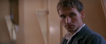 Movie still from “Jude” (1996), directed by Michael Winterbottom – A person wearing a suit and tie; Close Up shot, Over the shoulder angle