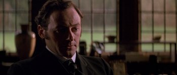 Movie still from “Jude” (1996), directed by Michael Winterbottom – A person wearing a suit and tie; Close Up shot, Low angle