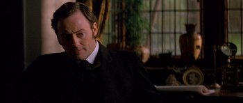 Movie still from “Jude” (1996), directed by Michael Winterbottom – A person wearing a suit and tie; Close Up shot, Low angle