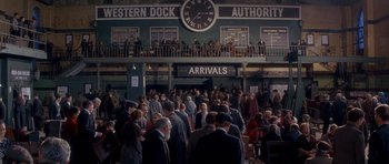 Movie still from “Jude” (1996), directed by Michael Winterbottom – A group of people standing in front of a train station; Extreme Wide shot, High angle