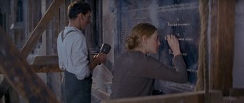 Movie still from “Jude” (1996), directed by Michael Winterbottom – A man and a woman writing on a wall; Medium shot, Low angle