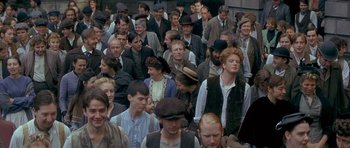 Movie still from “Jude” (1996), directed by Michael Winterbottom – A large group of people wearing hats and suits; Wide shot, High angle