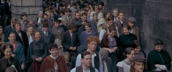 Movie still from “Jude” (1996), directed by Michael Winterbottom – A large group of people standing in a crowd; Wide shot, High angle