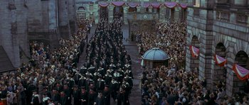 Movie still from “Jude” (1996), directed by Michael Winterbottom – A large crowd of people are gathered in the street; Extreme Wide shot, High angle