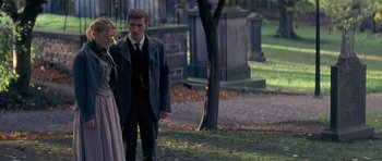 Movie still from “Jude” (1996), directed by Michael Winterbottom – A man and a woman standing next to each other in a cemetery; Medium shot, Over the shoulder angle
