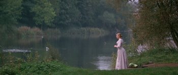 Movie still from “Jude” (1996), directed by Michael Winterbottom – A woman standing in front of a body of water; Wide shot, High angle