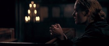 Movie still from “Jude” (1996), directed by Michael Winterbottom – A woman sitting in front of a candle light; Close Up shot, Over the shoulder angle