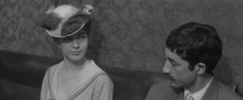 Movie still from “Jules and Jim” (1962), directed by François Truffaut – A man and a woman sitting next to each other on a couch; Close Up shot, Over the shoulder angle