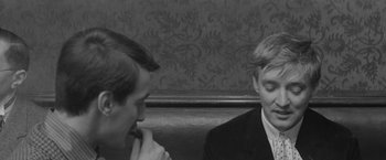 Movie still from “Jules and Jim” (1962), directed by François Truffaut – Two men sitting on a bench talking to each other; Close Up shot, Over the shoulder angle
